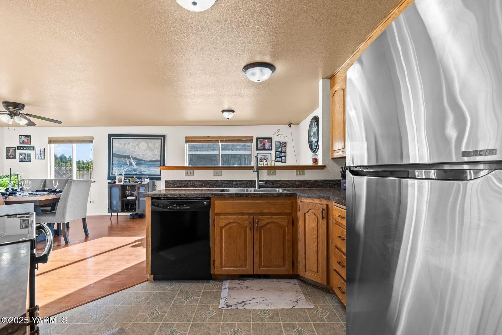 307 South 76th Avenue Yakima, WA 98908 - Photo 10 of 36 a kitchen with stainless steel appliances granite countertop a refrigerator and a sink