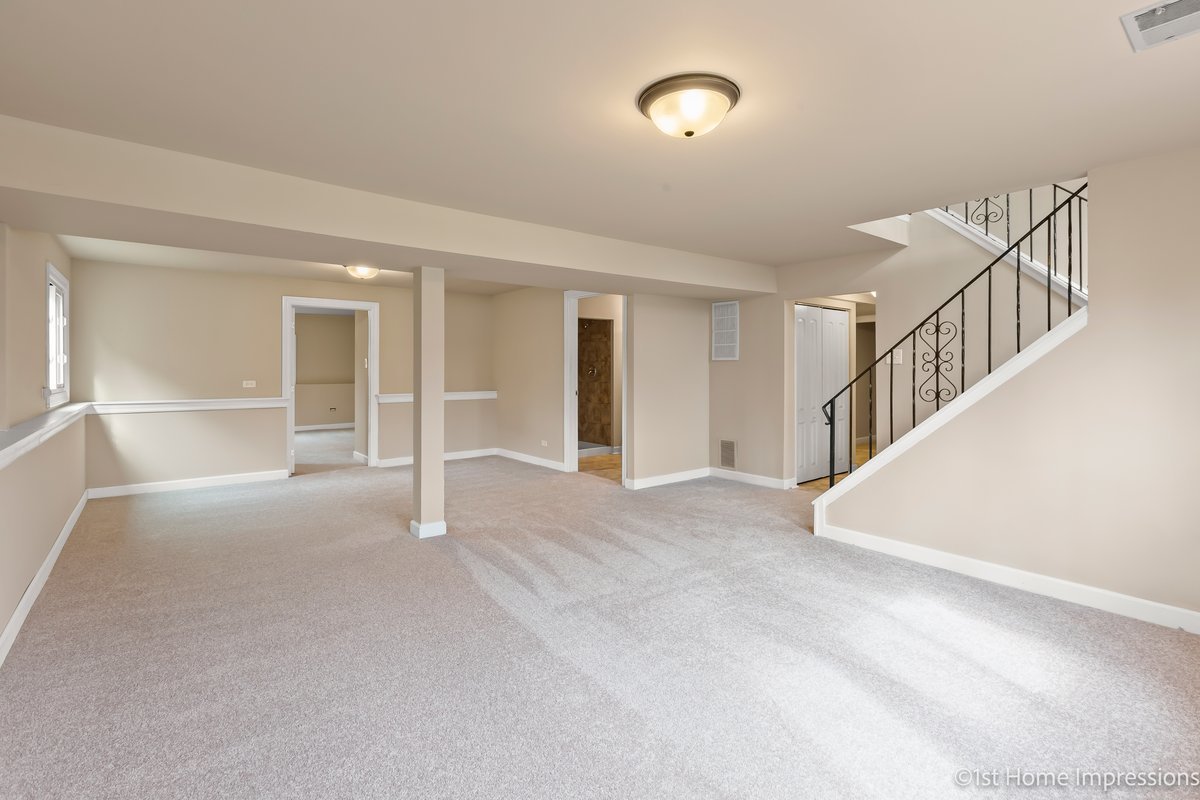17012 Magnolia Drive Hazel Crest, IL 60429 - Photo 14 of 23 a view of an empty room with stairs and a window