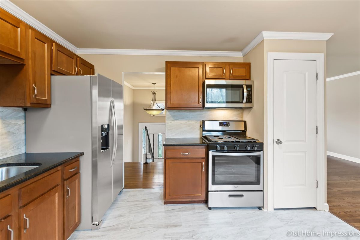 17012 Magnolia Drive Hazel Crest, IL 60429 - Photo 3 of 23 a kitchen with stainless steel appliances a stove a microwave and a refrigerator