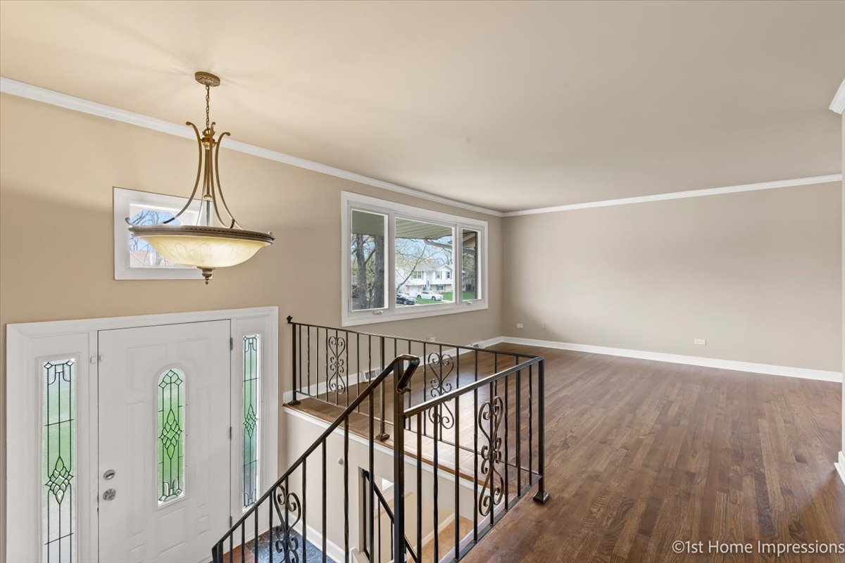 17012 Magnolia Drive Hazel Crest, IL 60429 - Photo 8 of 23 a view of a hallway with wooden floor and stairs