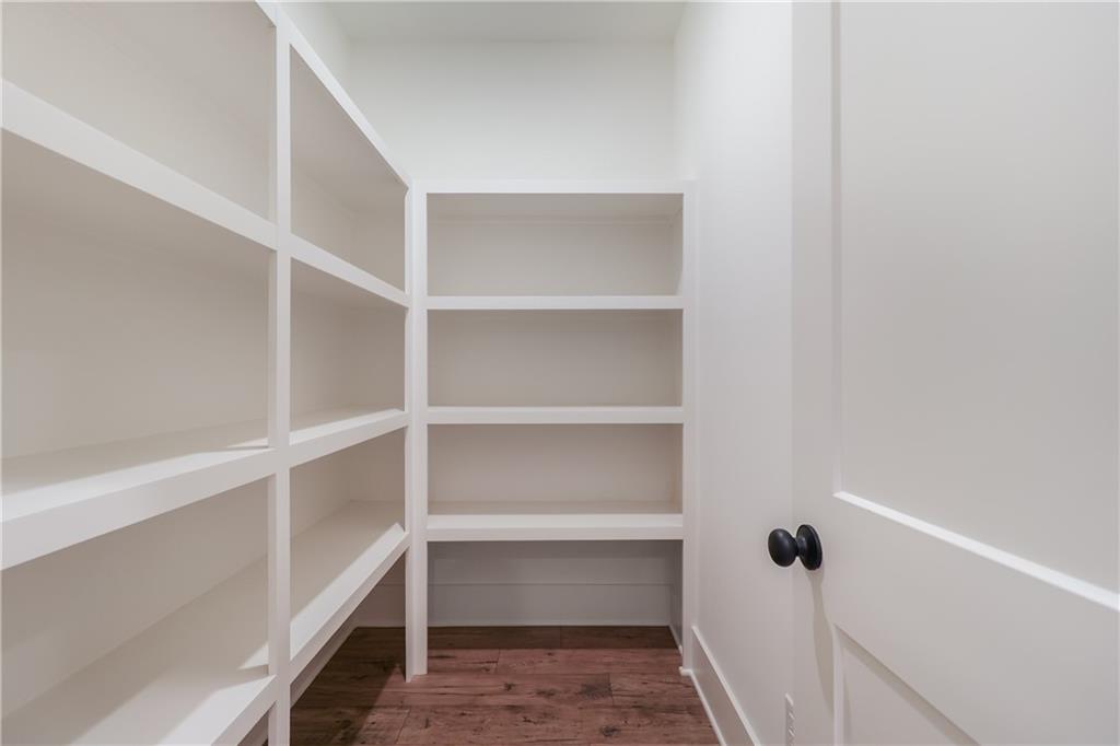 2113 Stonegate Way Monroe, GA 30656 - Photo 19 of 43 a view of walk in closet with empty racks
