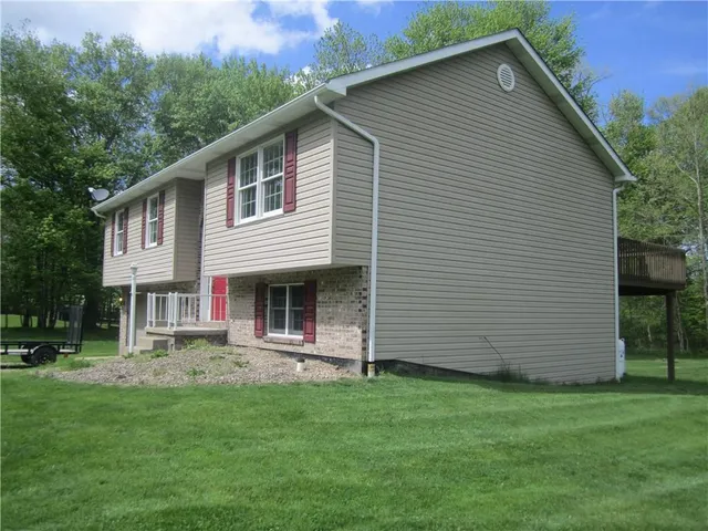 a front view of house with yard and green space