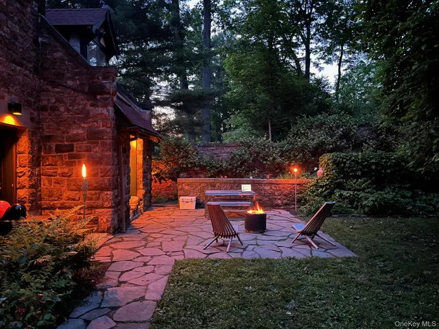 a view of a patio with table and chairs and potted plants