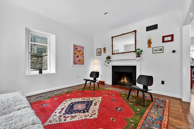 a view of a hallway with wooden floor and furniture
