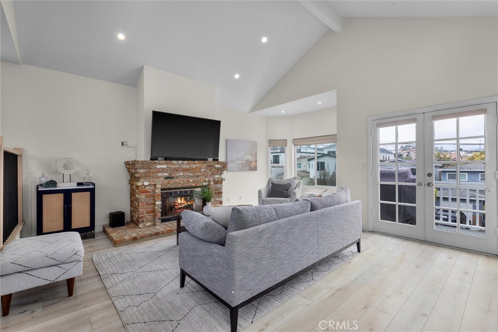 1727 Spreckels Lane Redondo Beach, CA 90278 - Photo 2 of 35 a living room with furniture a fireplace and a flat screen tv
