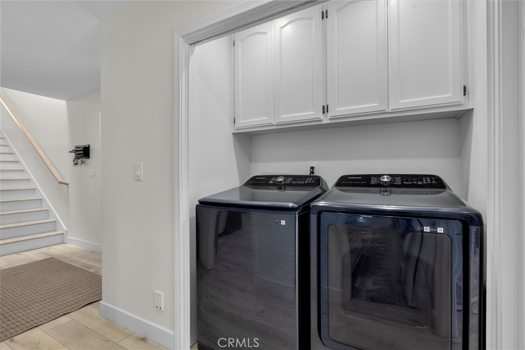 1727 Spreckels Lane Redondo Beach, CA 90278 - Photo 29 of 35 a view of washer and dryer with wooden cabinet