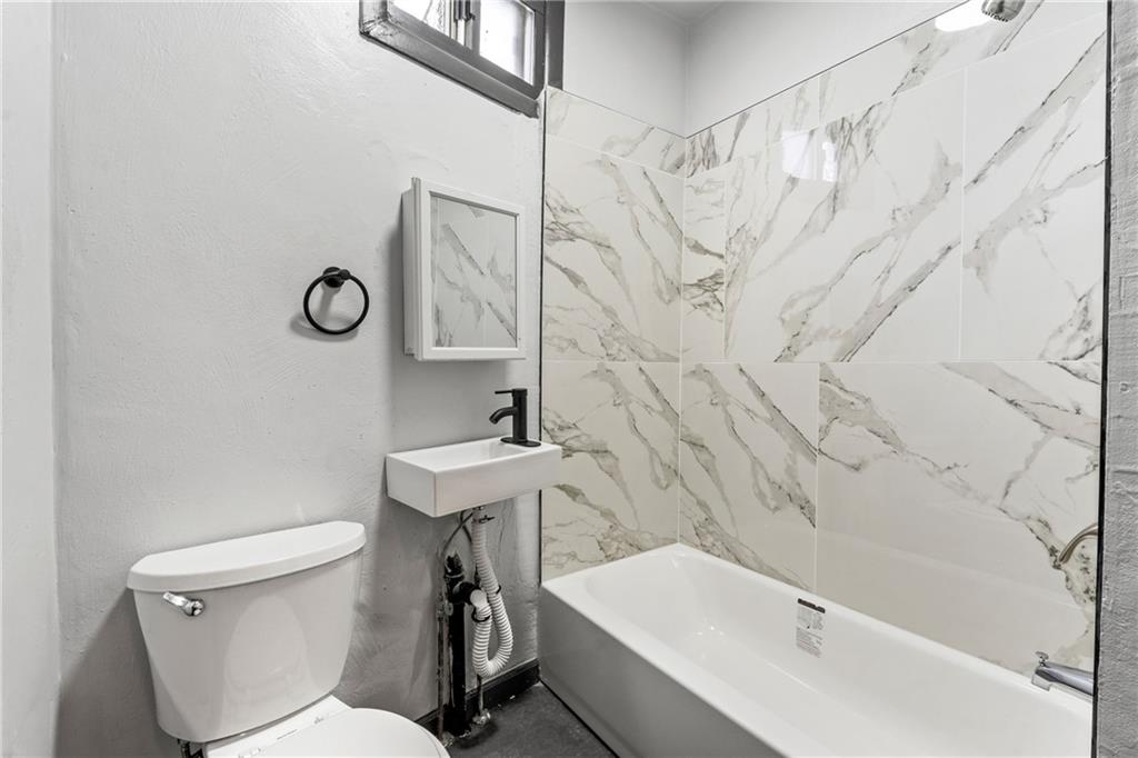 1306 Complete Street Pittsburgh, PA 15212 - Photo 12 of 24 a bathroom with a sink a toilet and a bathtub