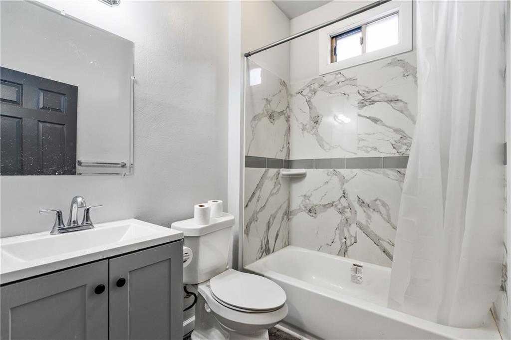 1306 Complete Street Pittsburgh, PA 15212 - Photo 18 of 24 a bathroom with a sink a toilet and a bathtub