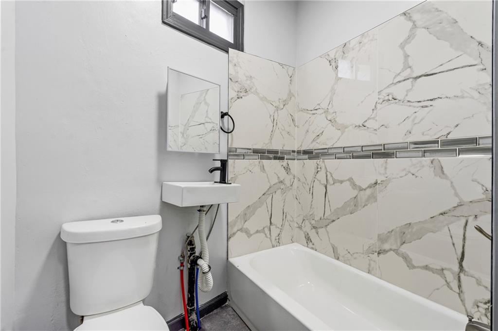 1306 Complete Street Pittsburgh, PA 15212 - Photo 7 of 24 a bathroom with a sink a toilet and shower