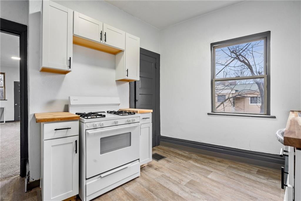1306 Complete Street Pittsburgh, PA 15212 - Photo 9 of 24 a kitchen with stainless steel appliances a stove and a refrigerator