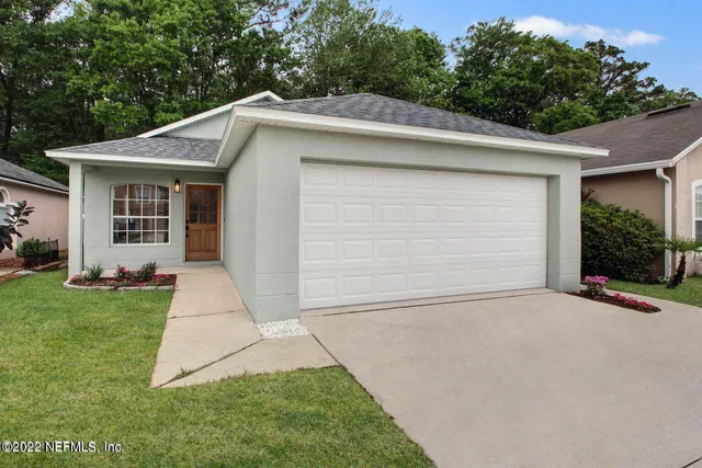 a front view of a house with garage