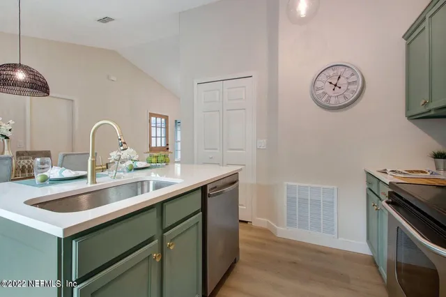 a kitchen with a sink cabinets and stainless steel appliances