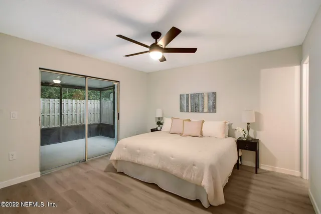 a bedroom with a large bed and a fan