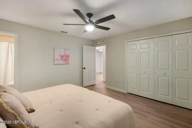 a bedroom with a large bed and a chandelier