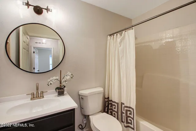 a bathroom with a sink toilet and a mirror
