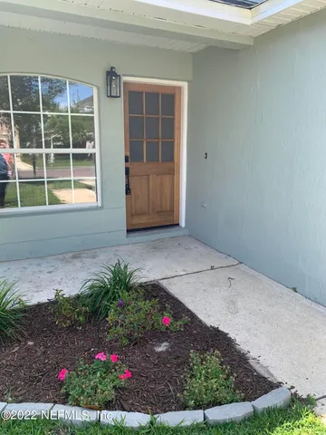 a view of house with backyard and garden