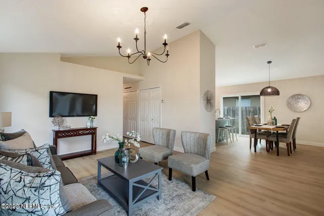 a living room with furniture a rug and a flat screen tv