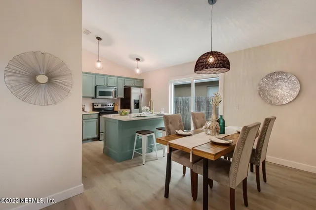 a dining room with furniture and window