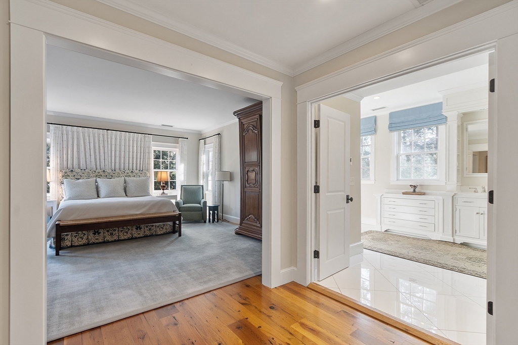 315 Musketaquid Road Concord, MA 01742 - Photo 27 of 41 a spacious bedroom with a bed and glass door