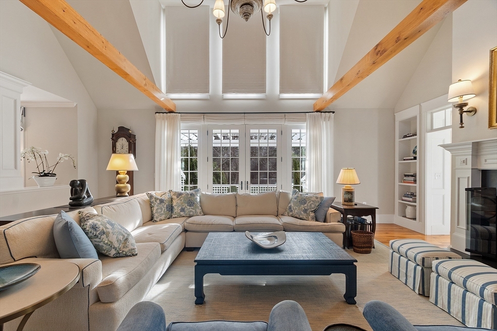 315 Musketaquid Road Concord, MA 01742 - Photo 5 of 41 a living room with furniture fireplace and a large window
