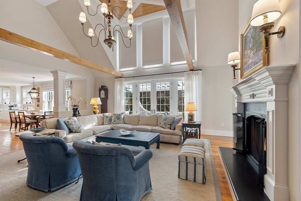 315 Musketaquid Road Concord, MA 01742 - Photo 6 of 41 a living room with furniture a chandelier a fireplace and a chandelier