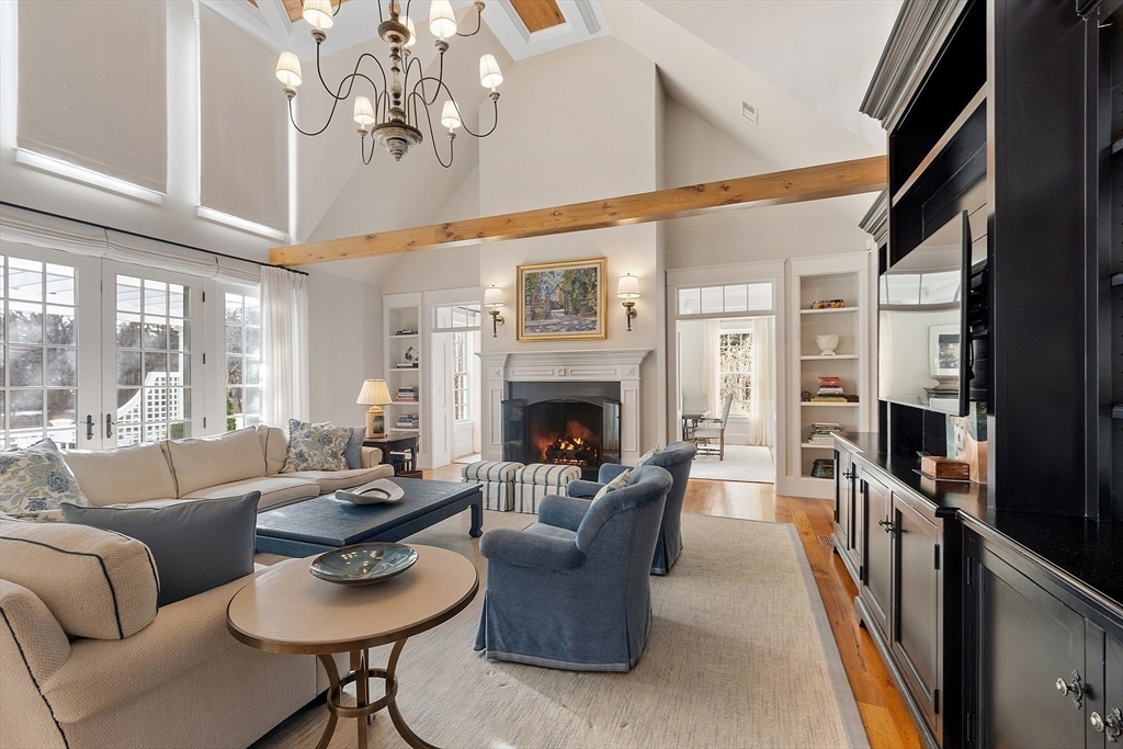 315 Musketaquid Road Concord, MA 01742 - Photo 7 of 41 a living room with furniture a fireplace and a chandelier