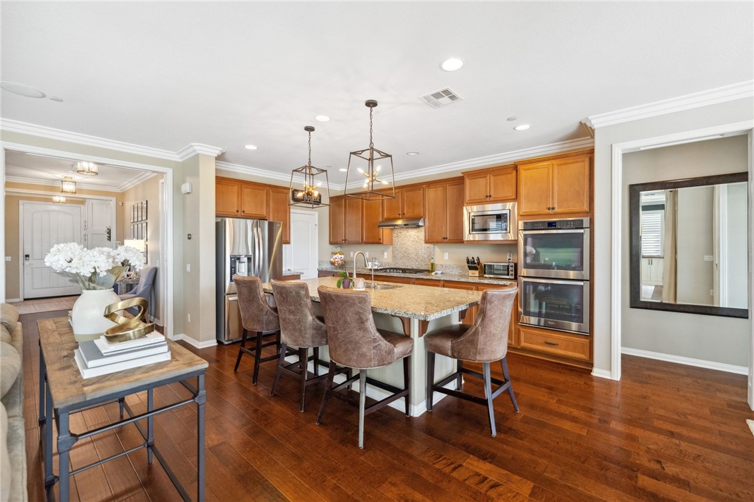 39148 Steeplechase Lane Temecula, CA 92591 - Photo 11 of 65 a dining room with furniture a chandelier and wooden floor