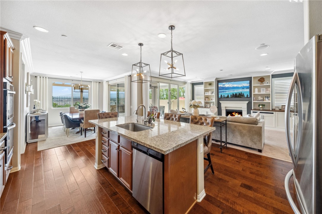 39148 Steeplechase Lane Temecula, CA 92591 - Photo 13 of 65 a kitchen with counter top space and wooden floor