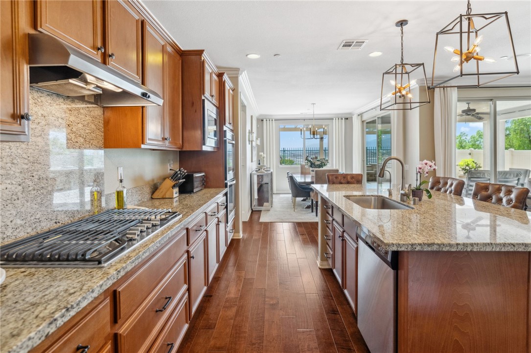 39148 Steeplechase Lane Temecula, CA 92591 - Photo 14 of 65 a kitchen with sink stove and cabinets