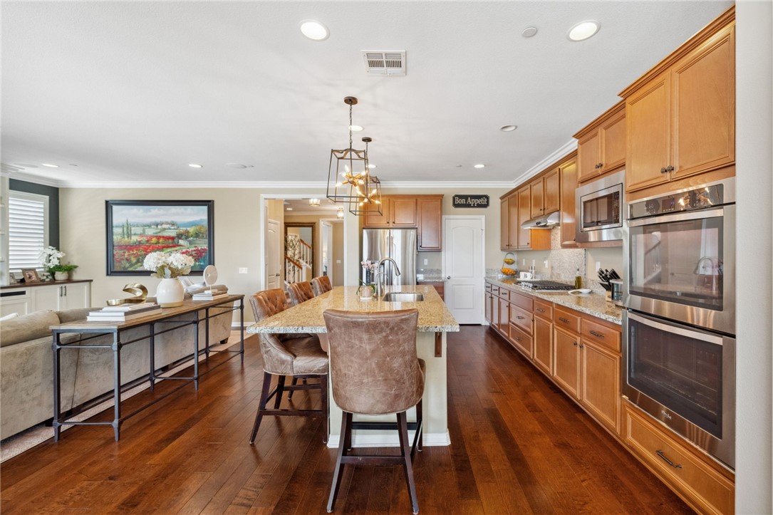 39148 Steeplechase Lane Temecula, CA 92591 - Photo 16 of 65 a large kitchen with a table and chairs
