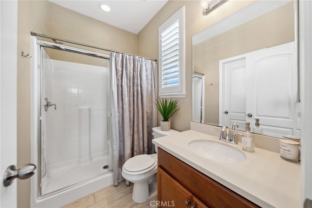 39148 Steeplechase Lane Temecula, CA 92591 - Photo 21 of 65 a bathroom with a granite countertop sink toilet and shower