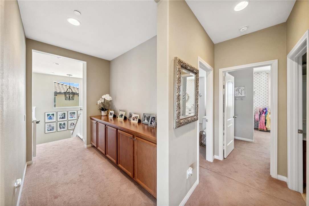 39148 Steeplechase Lane Temecula, CA 92591 - Photo 26 of 65 a view of a hallway and a livingroom with furniture