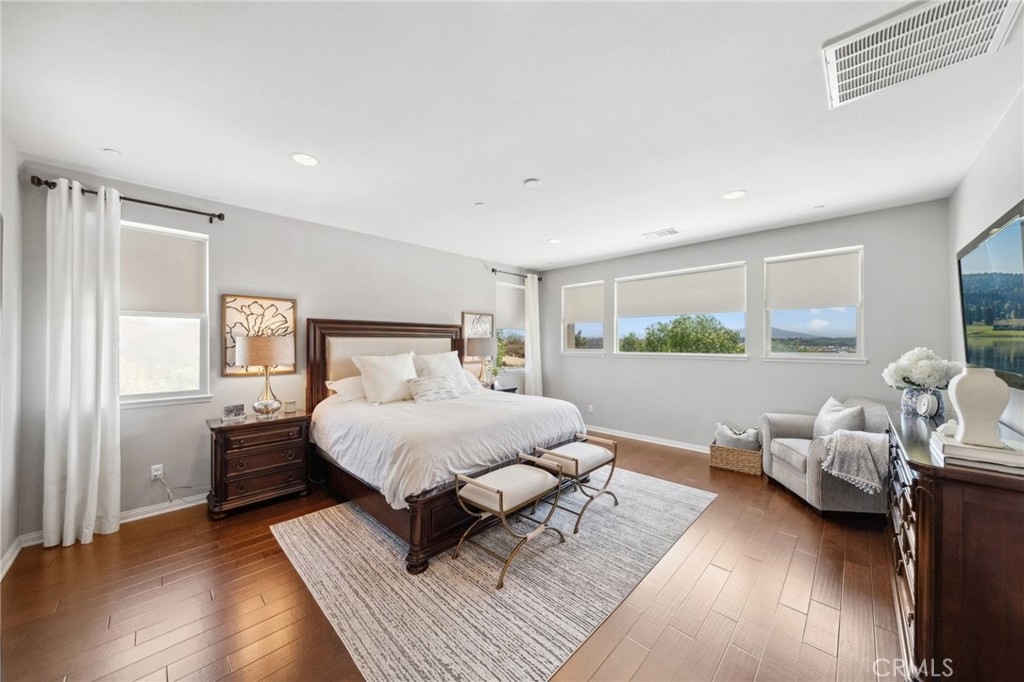 39148 Steeplechase Lane Temecula, CA 92591 - Photo 31 of 65 a bedroom with a bed and wooden floor