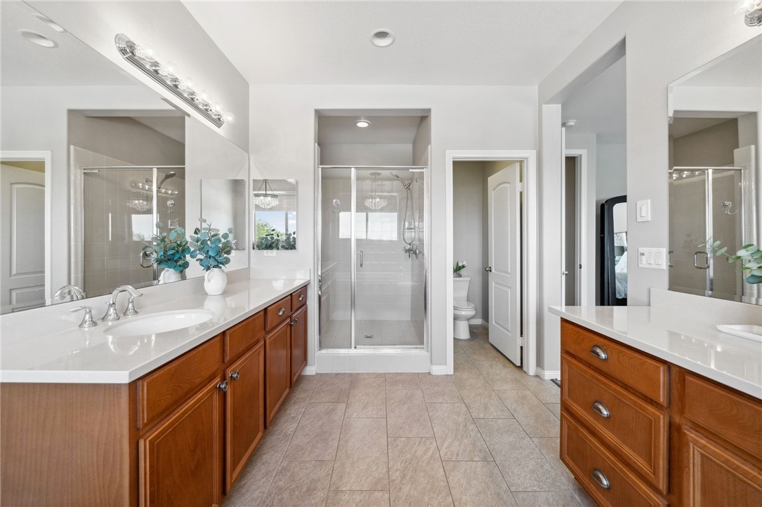 39148 Steeplechase Lane Temecula, CA 92591 - Photo 34 of 65 a bathroom with a granite countertop sink mirror and double