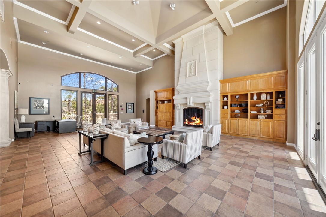 39148 Steeplechase Lane Temecula, CA 92591 - Photo 55 of 65 a living room with fireplace furniture and a floor to ceiling window