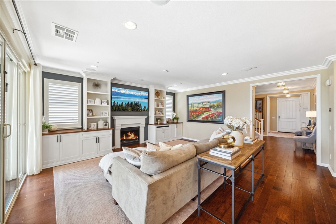 39148 Steeplechase Lane Temecula, CA 92591 - Photo 9 of 65 a living room with furniture a fireplace and a floor to ceiling window