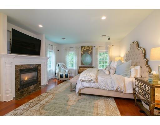 26 Tyler Road Lexington, MA 02420 - Photo 11 of 29 a spacious bedroom with a bed and a fireplace