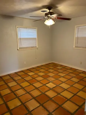 a view of a room with a window and ceiling fan