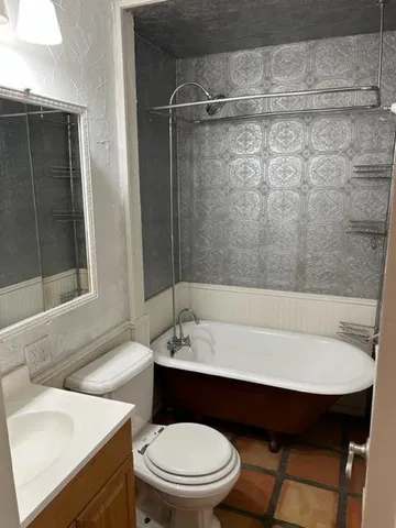 a bathroom with a sink a toilet and bathtub