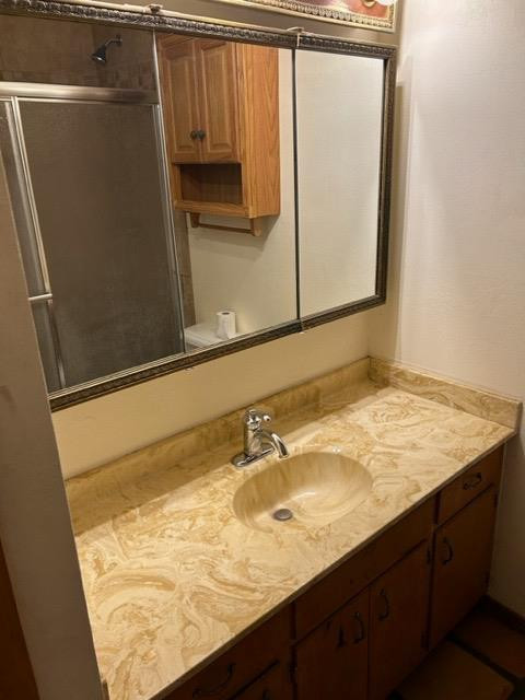 5313 46th Street Lubbock, TX 79414 - Photo 8 of 10 a bathroom with a sink and a mirror