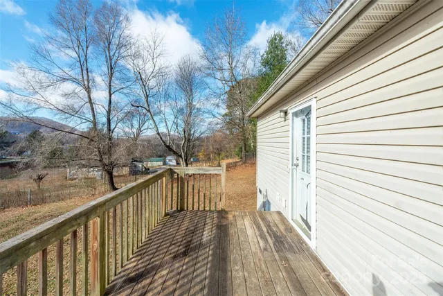 a view of a balcony with wooden floor and fence