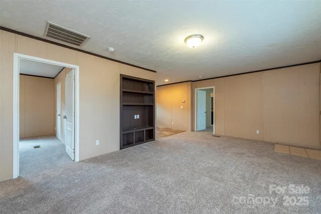 a view of an empty room and closet area
