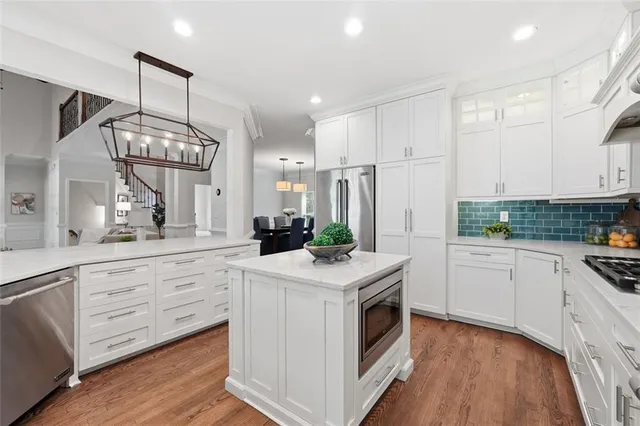a kitchen with white cabinets and a stove