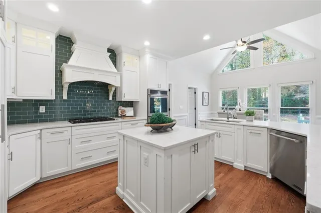 a kitchen with white cabinets and a stove