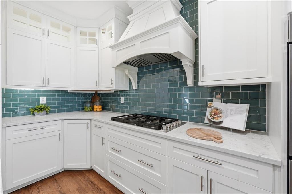1520 Natchez Way Grayson, GA 30017 - Photo 23 of 63 a kitchen with white cabinets and a stove