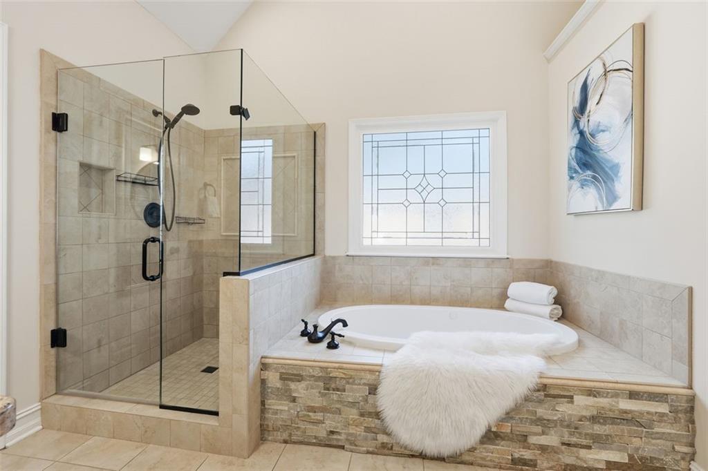 1520 Natchez Way Grayson, GA 30017 - Photo 30 of 63 a bathroom with a bathtub and shower