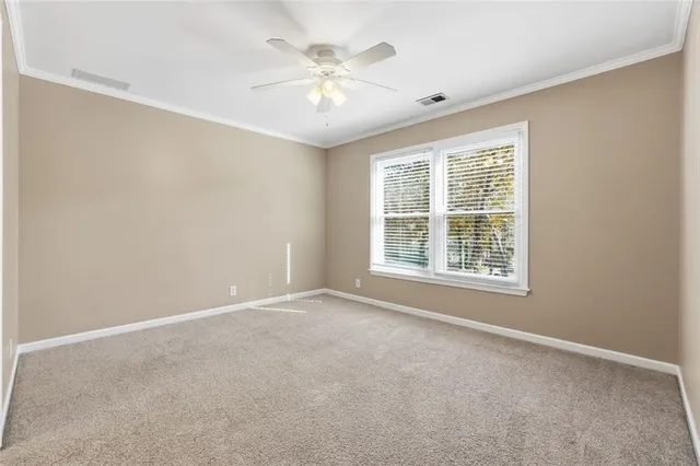 an empty room with windows and garden view