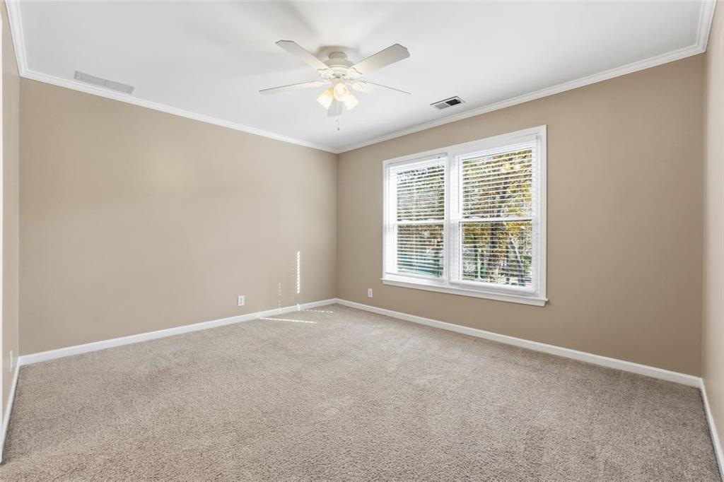 1520 Natchez Way Grayson, GA 30017 - Photo 33 of 63 an empty room with windows and chandelier fan