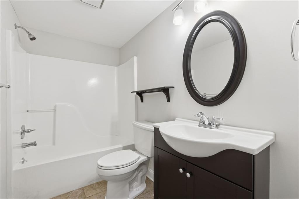 1520 Natchez Way Grayson, GA 30017 - Photo 39 of 63 a bathroom with a sink a toilet and a mirror