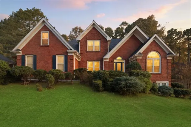 a front view of a house with a yard